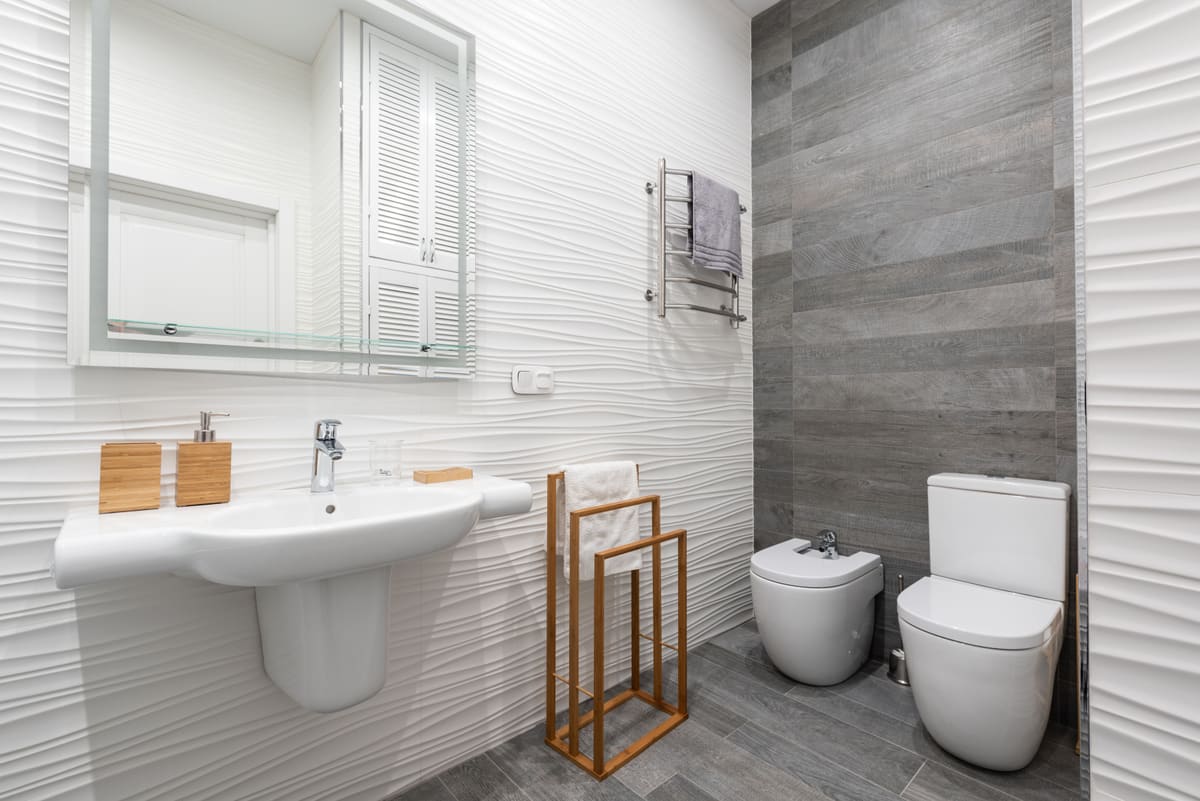Bathroom with a basin and toilet set out with clear space around them