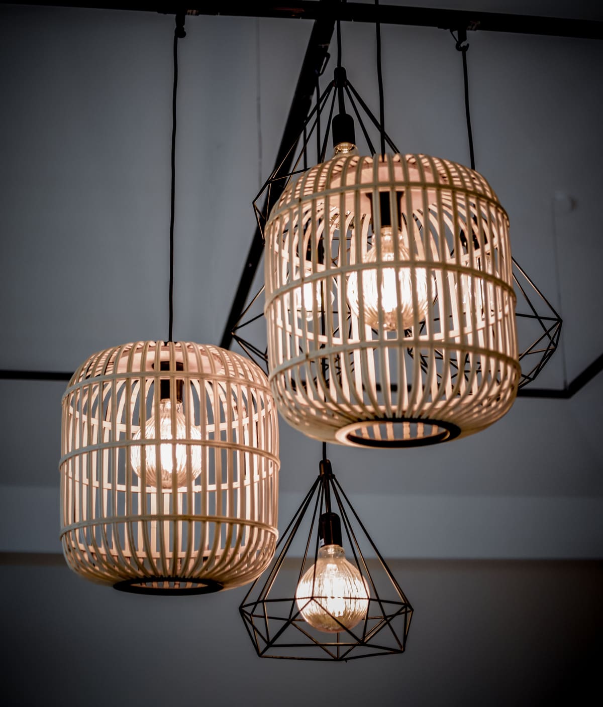 Pendants hung at a set height and anchored above the ceiling board, not into it.