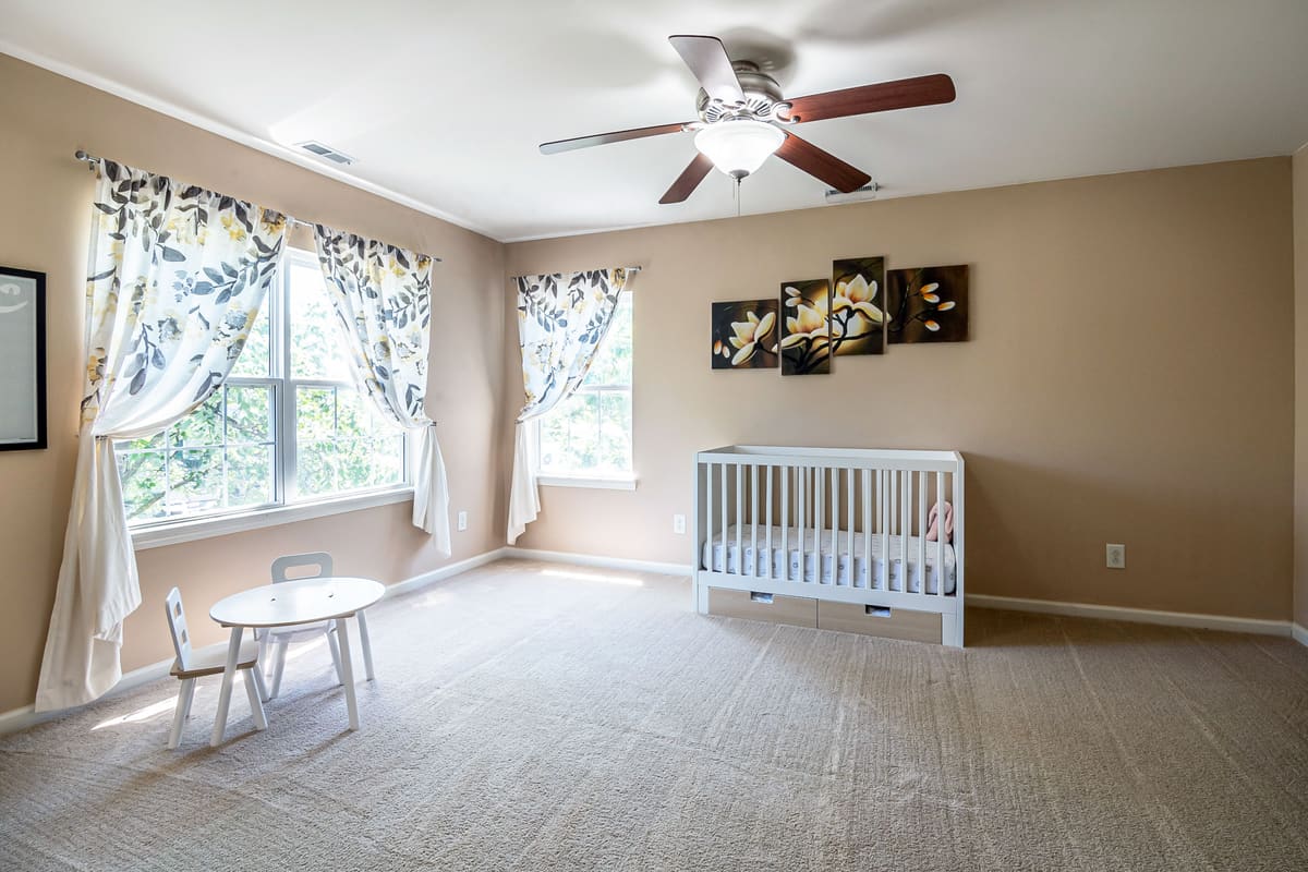 Ceiling fan mounted centrally in a bedroom