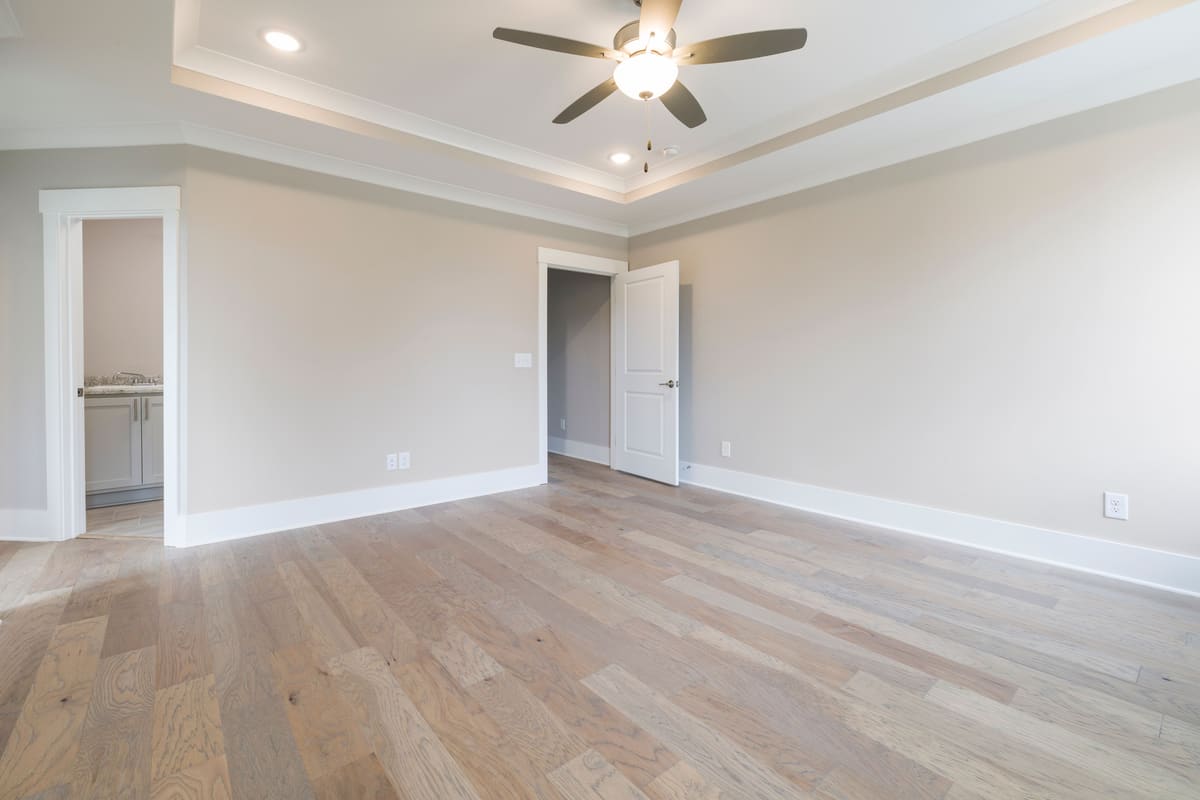 Empty room with hardwood flooring photographed ready for listing