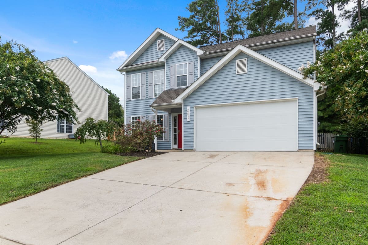 Double garage door on a suburban home with a clear driveway approach