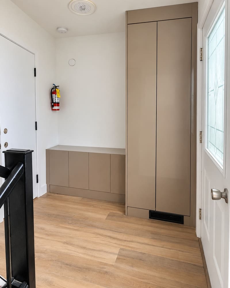 Custom cabinetry and a bench built into a Kitchener mudroom, fitted flush to the wall.