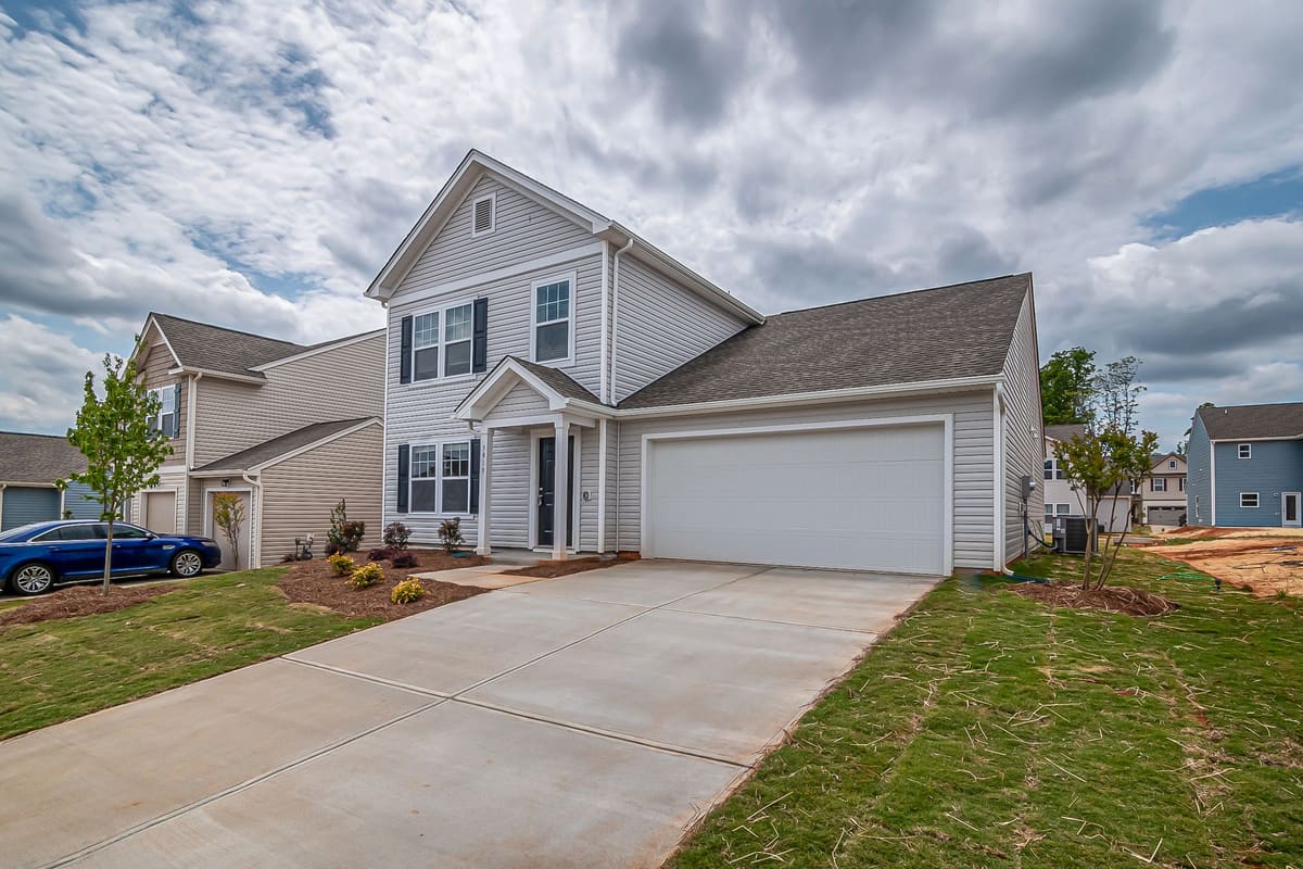 Detached two-storey Kitchener home with an attached garage and a freshly cut front lawn