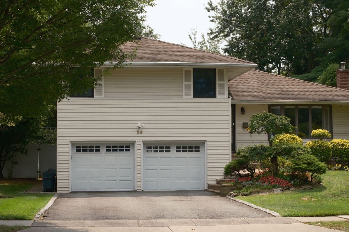 Waterloo home with a double garage and mature planting along the driveway